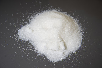 Obraz na płótnie Canvas White sugar scattered on the table.