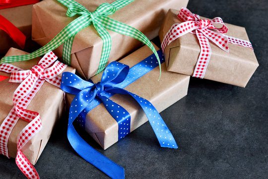 Happy New Year - Christmas gifts in boxes with ribbons on a black  background