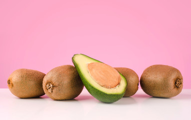 Fresh kiwi and sliced avocado on a table