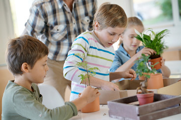 Teacher with kids in biology class learning about plants