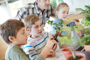 Teacher with kids in biology class learning about plants