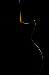 Electric guitar gold silhouette on a black background