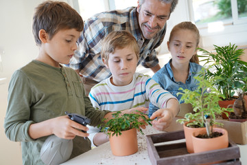 Teacher with kids in biology class learning about plants