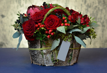 Bouquet of red roses in a box of birch bark