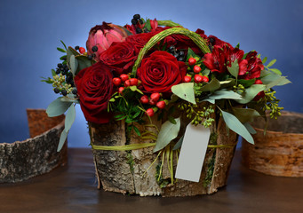 Bouquet of red roses in a box of birch bark