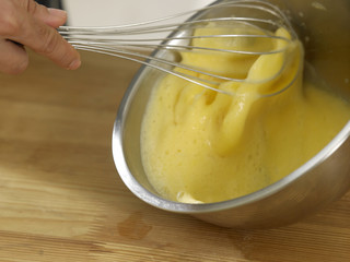 hands beating eggs