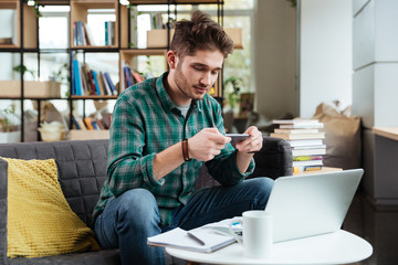 Man making photo on sofa