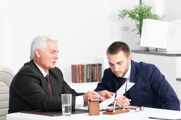 Young man with notary at office