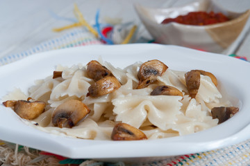Farfalle Pasta - with mushrooms on white plate