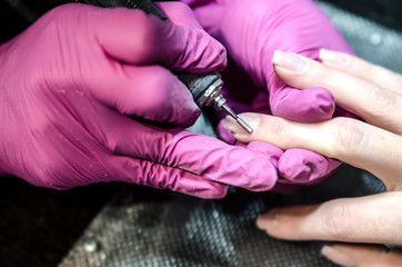 Hardware manicure with a router. The process of removing the cuticles.