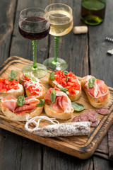 Set Italian snacks served on wooden board with wine