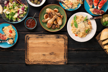 Kitchen board with different Italian food and snacks