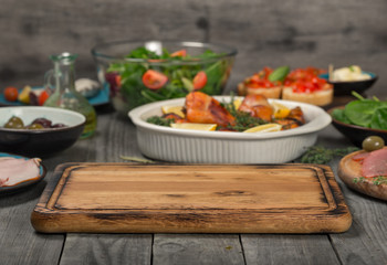 kitchen board on wooden table in the background variety food