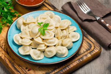 Ravioli with red sauce on the wooden table