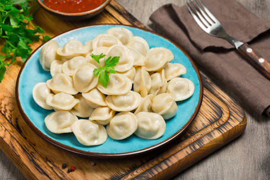 Ravioli With Red Sauce On The Wooden Table