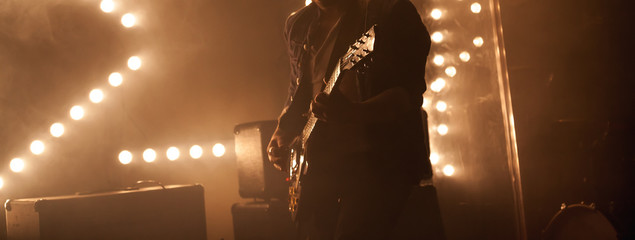 Electric guitar player on a stage, rock