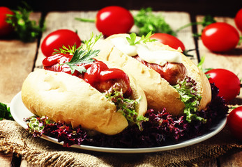 Hot dog with ketchup and mayonnaise, vintage wooden background,