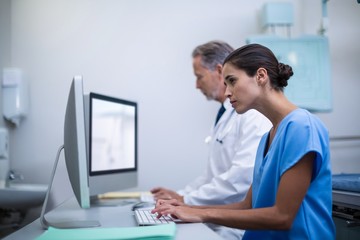 Doctor and nurse working on computer
