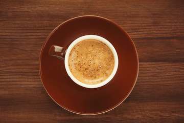 Cup of coffee on wooden background