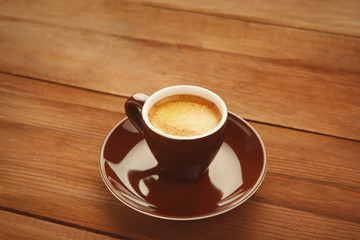 Cup of coffee on wooden background