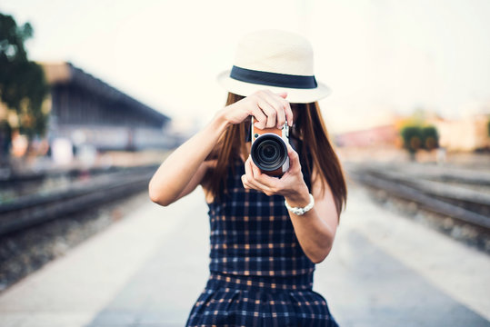 The hipster woman take a photo for travel on the street