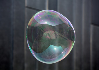 The transparent, iridescent soap bubbles  on black background