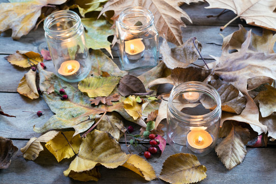  Candles Burning Between Dry Leaves