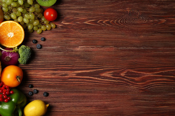 Set of fresh vegetables, fruits and berries on wooden background