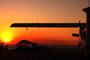 Shadow of a small landed plane and the sunset sky background