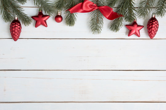 Christmas tree branches border decorations with red ornaments