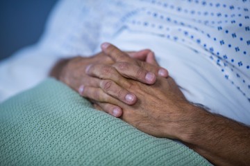 Fototapeta premium Patient relaxing on bed with hands clasped