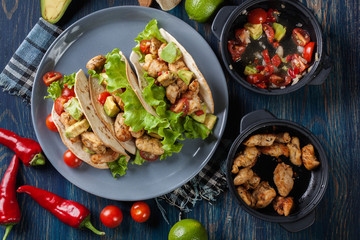 Authentic mexican tacos with chicken and salsa with avocado, tom