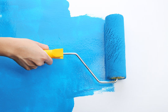 Decorator's Hand Painting Wall With Roller