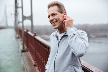 Runner listening to music on bridge