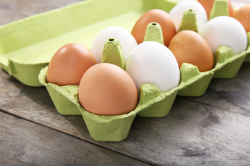 Eggs package on wooden background