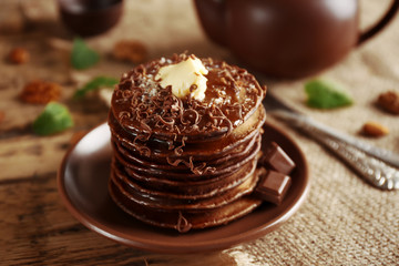 Tasty pancakes with chocolate sauce on plate