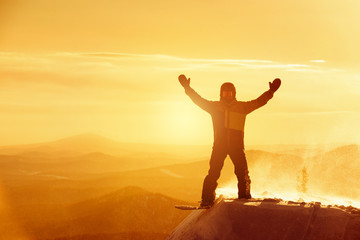 Happy snowboarder win winner pose ski resort sunset