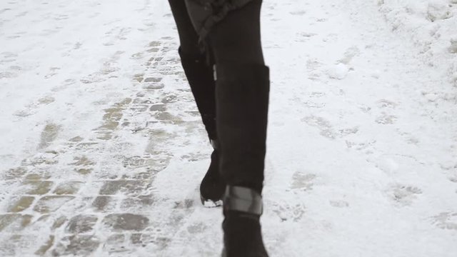 female legs in boots go on camera on snow