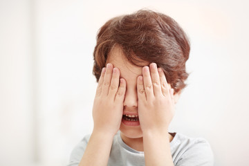 Fototapeta premium Cute emotional little boy on light blurred background