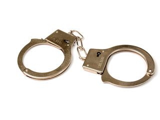 metal handcuffs lying on a white background