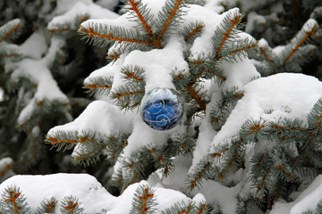 Christmas New Year's toy on a snow-covered Christmas tree