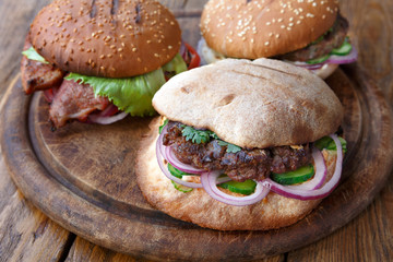 Classic american burgers, fast food on wood background