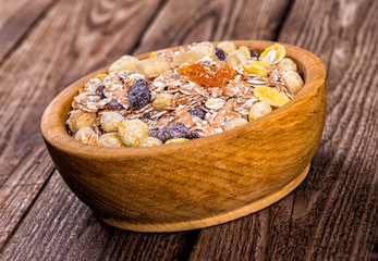 oatmeal in a sac, dried apricots, raisins, grapes, nuts on the b