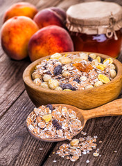 oatmeal in a sac, dried apricots, raisins, grapes, nuts on the b