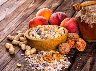 oatmeal in a sac, dried apricots, raisins, grapes, nuts on the b