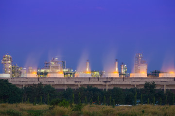 Cooling tower of oil refinery industrial plant at night, Thailan
