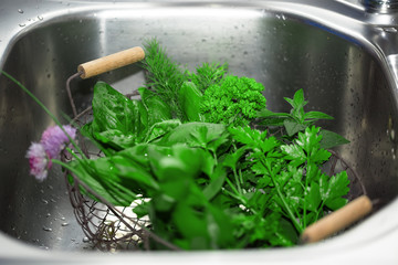 Sieve with herbal from garden in a sink. Selective focus