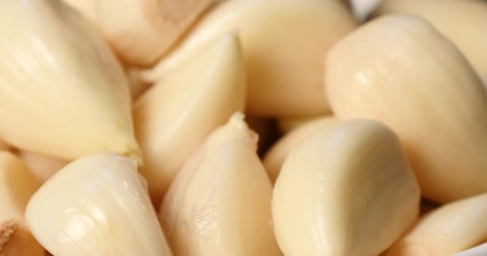 Close up of peeled garlic in rotation