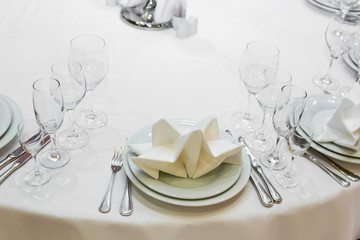 catering table set service with silverware, napkin and glass at restaurant before party