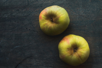 Apples on the dark scratched background horizontal